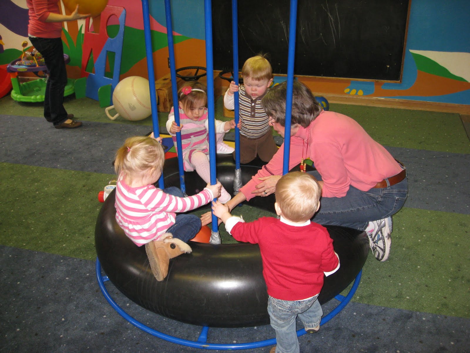 Children playing on a bouncy tire
